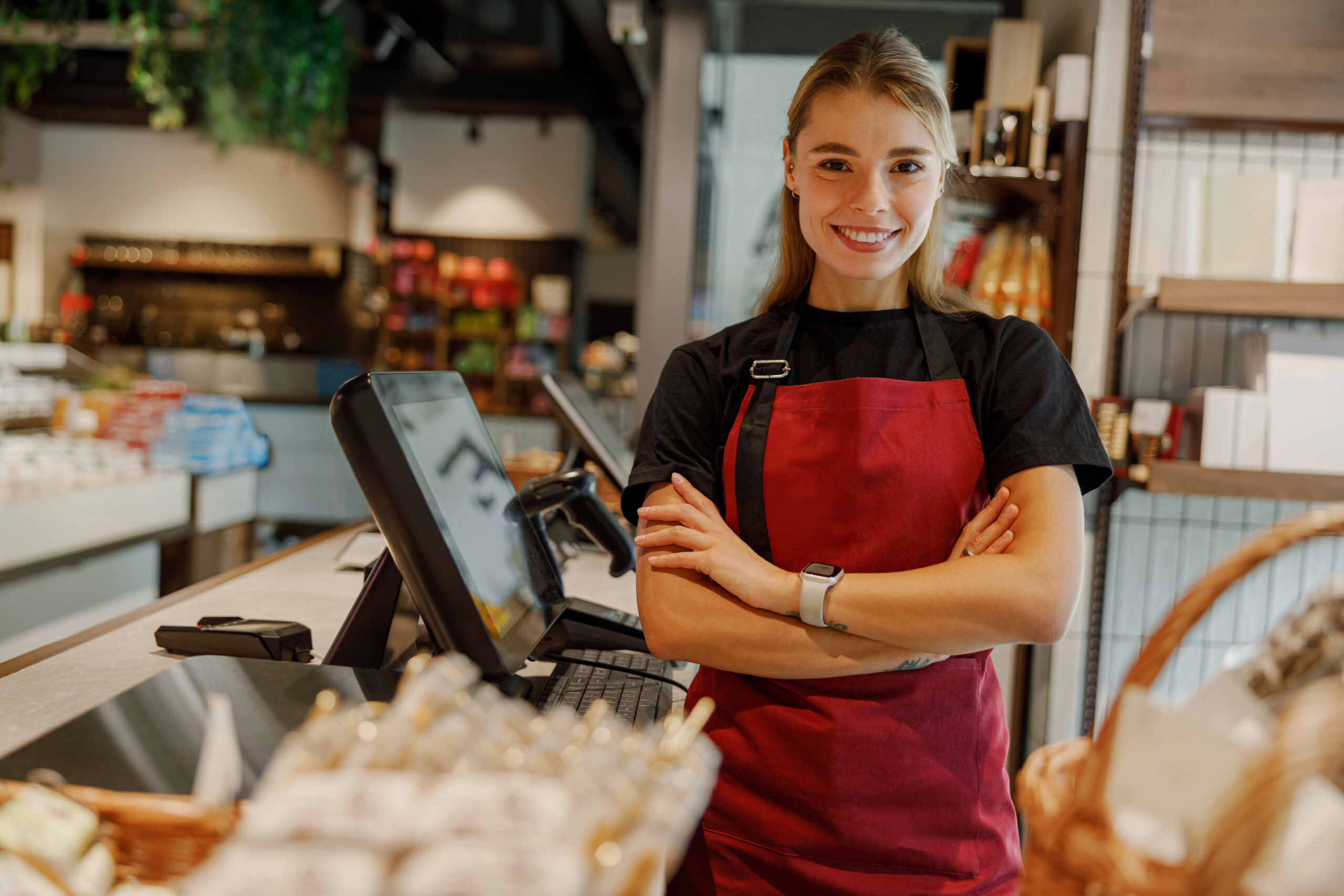 In a modern cafe, a cheerful barista serves delightful drinks and tasty pastries to customers service-section-image-4