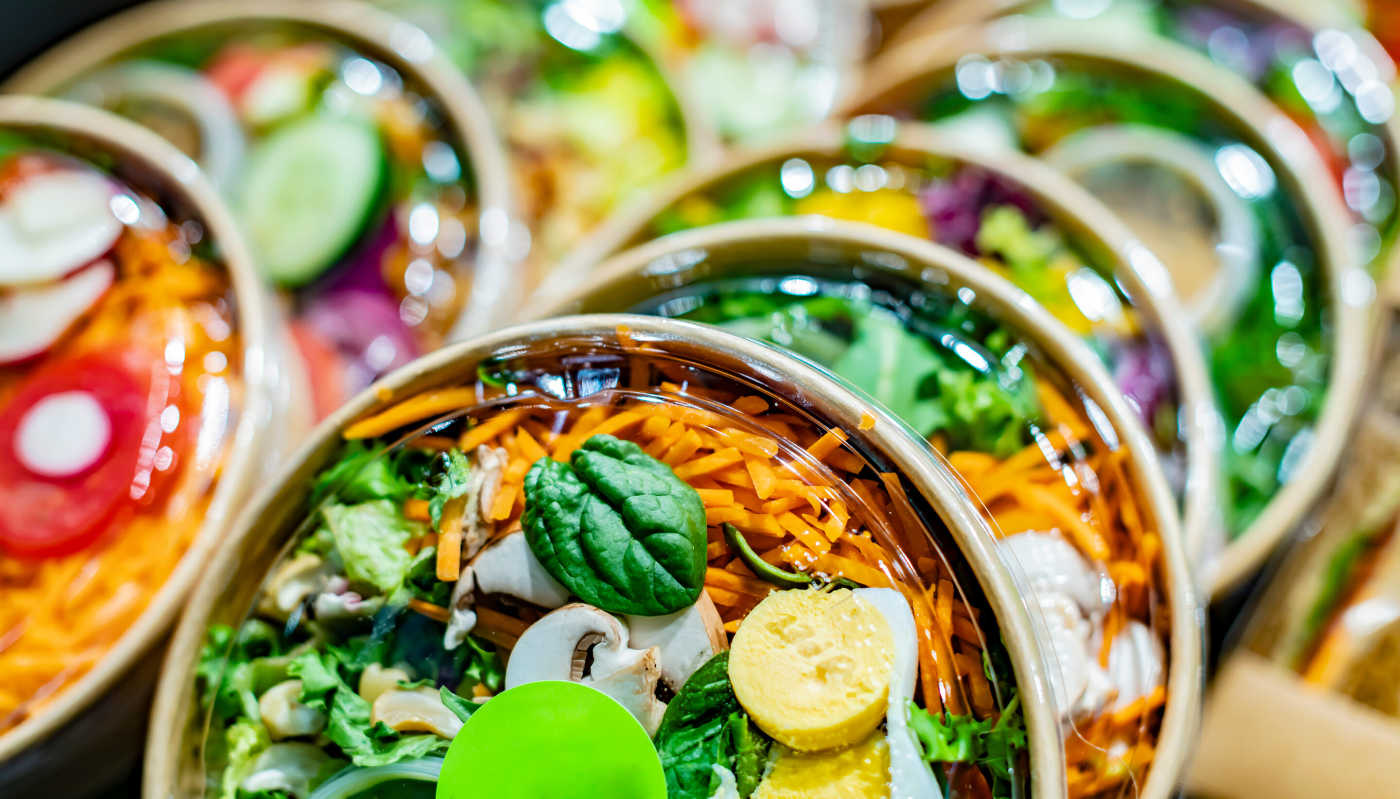 Vegetable salads displayed in a commercial refriger Divi-About-Us-Section-Hero-Image-2